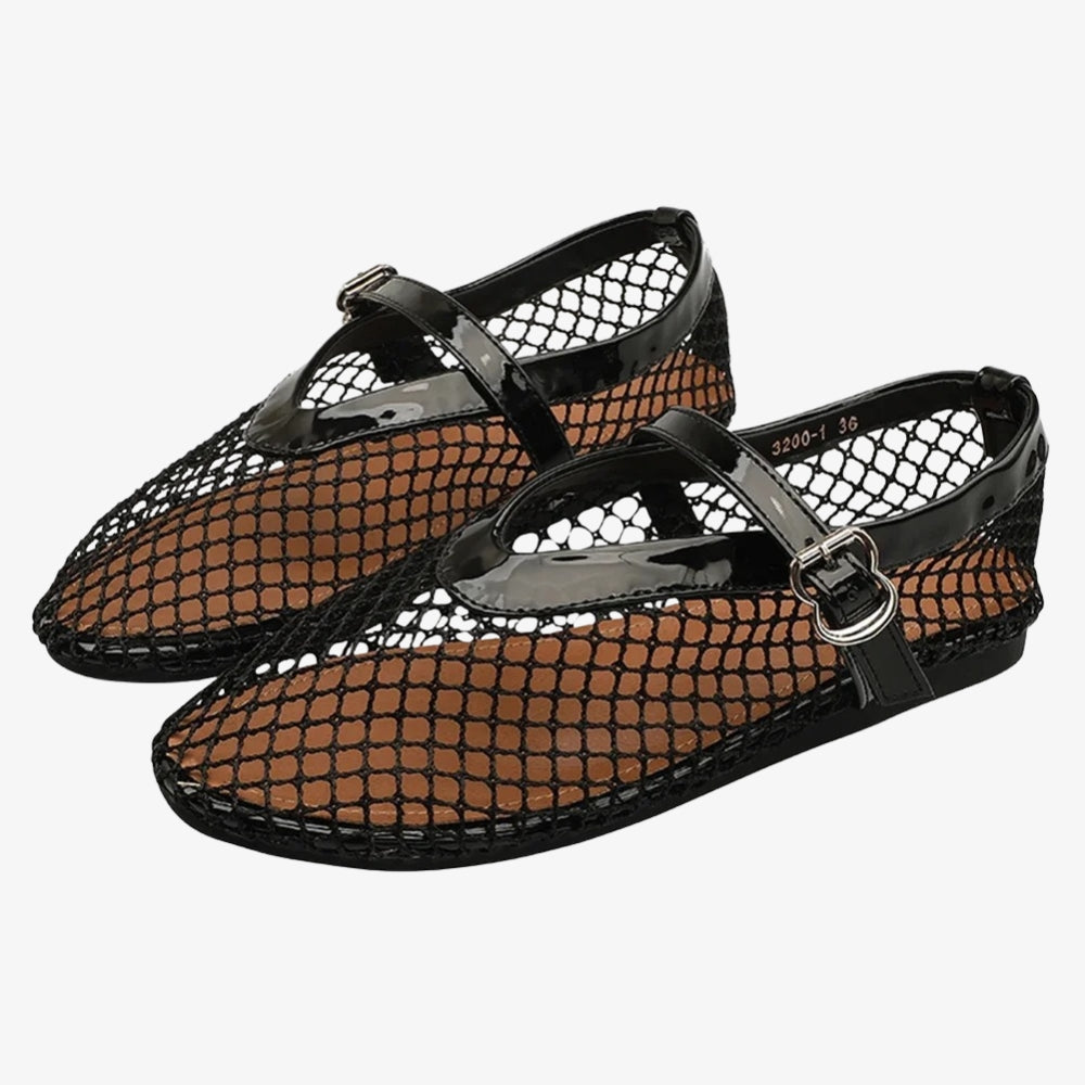 Schwarze Loafer-Ballerina aus Netz mit einem Lackriemen im Mary-Jane-Stil, auf grauem Hintergrund